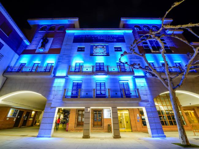 La fachada del Ayuntamiento iluminada de azul como muestra de apoyo a quienes padecen esta enfermedad y a sus familiares